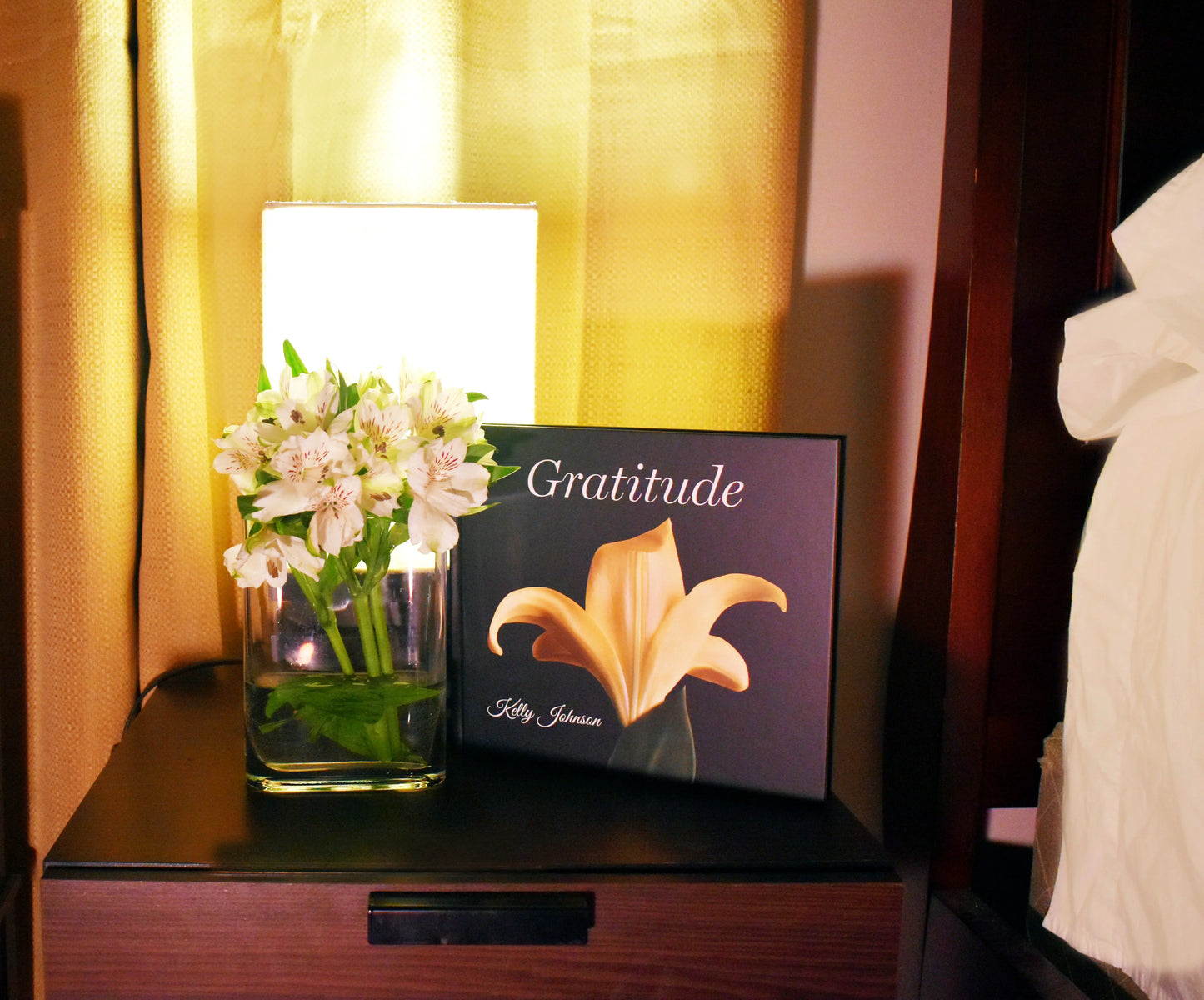 Book: Gratitude, a picture of a yellow lily on a nightstand